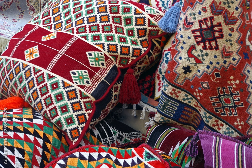 Obraz premium Picture of colored oriental pillows and textile with traditional design.