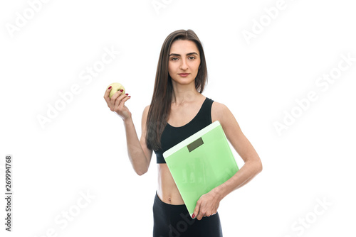 Woman with scale and apple isolated on white