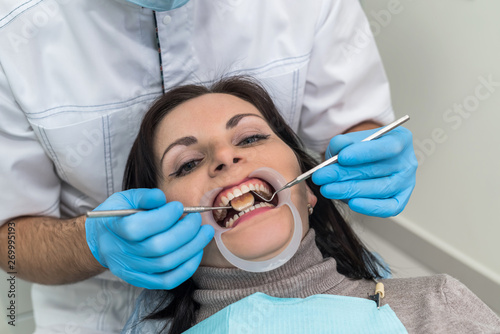Doctor making treatment procedures in dentistry close up