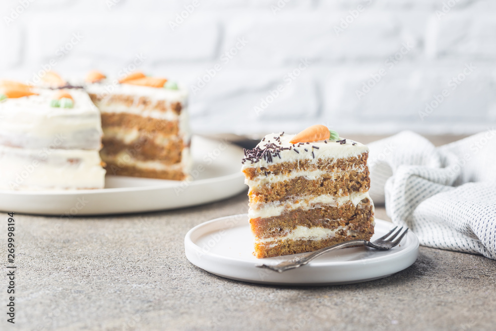 Healthy homemade carrot cake with cream cheese frosting on light stone background Healthy homemade carrot cake with cream cheese frosting on light stone background