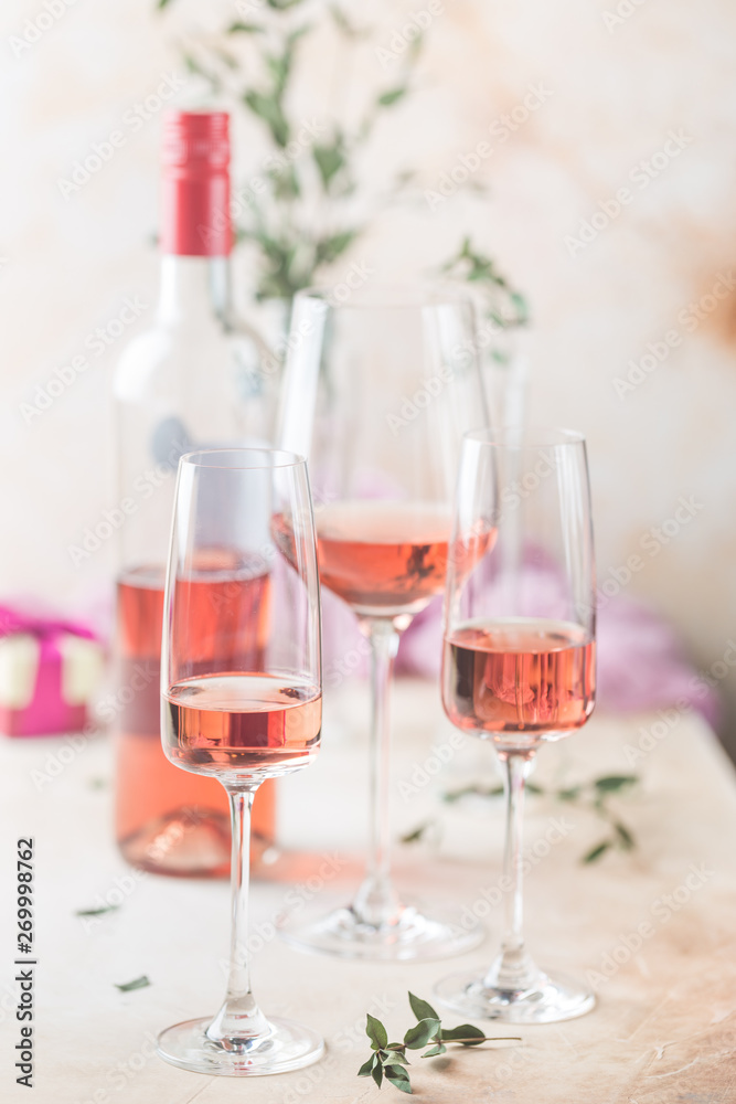 Different glasses and bottle of rose wine on light background. Different glasses and bottle of rose wine on light background.