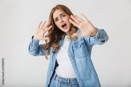 Fotografija Attractive young girl standing isolated over white