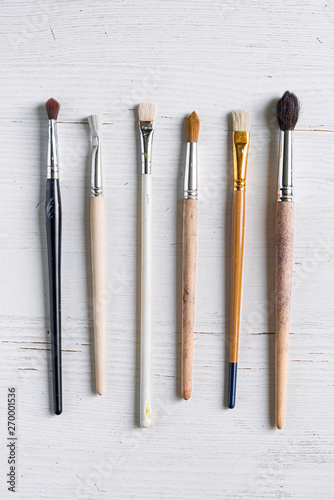 drawing brushes - supplies on a white wooden table