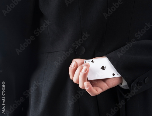 Businessman with ace card hidden under sleeve
