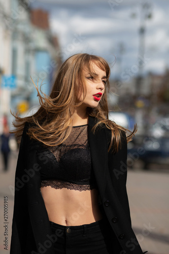 Outdoor fashion portrait of seductive young woman wearing lace lingerie and jacket