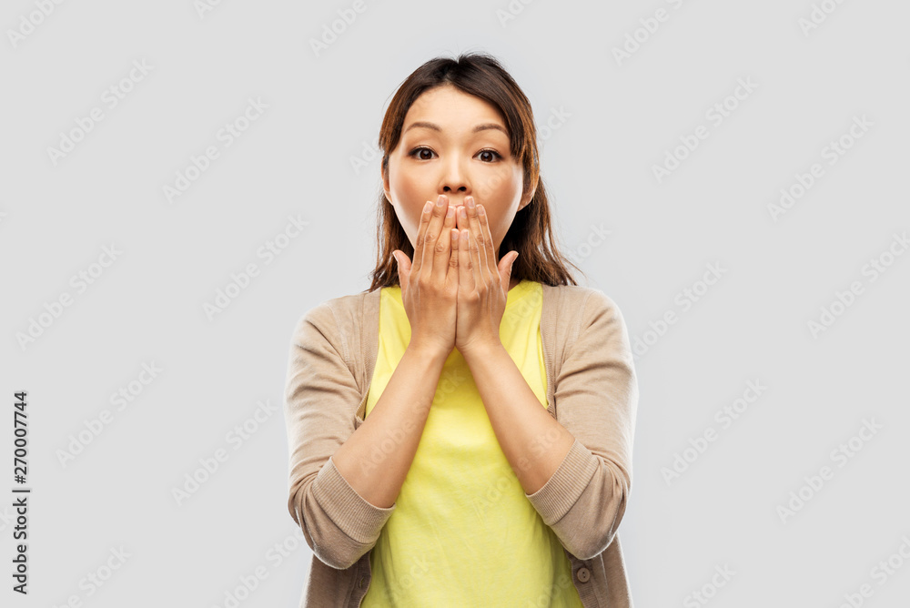 emotion, expression and people concept - scared asian woman over grey background emotion, expression and people concept - scared asian woman over grey background