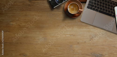 Laptop with coffee on wooden table. panoramic banner