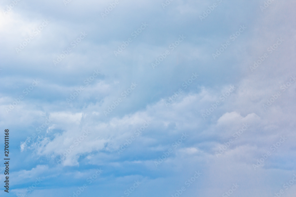 white cumulus clouds in the form of cotton wool on a blue sky. background, bright sky texture white cumulus clouds in the form of cotton wool on a blue sky. background, bright sky texture