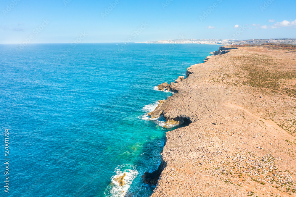 Cliff on the picturesque coast of the Mediterranean Sea with turquoise water, coastline from a height aerial view.