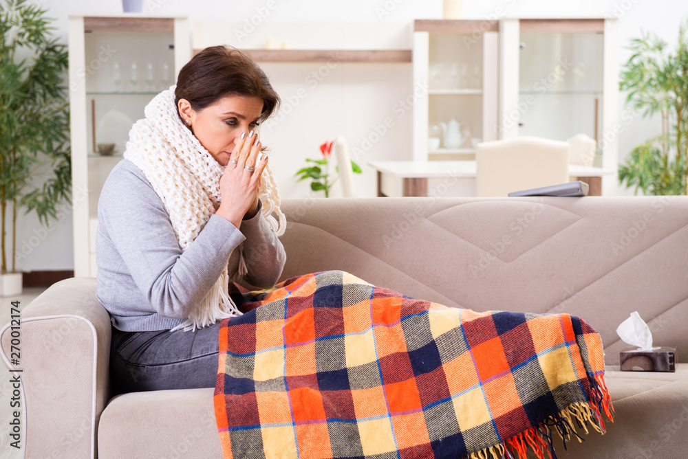 Sick middle-aged woman suffering at home Sick middle-aged woman suffering at home