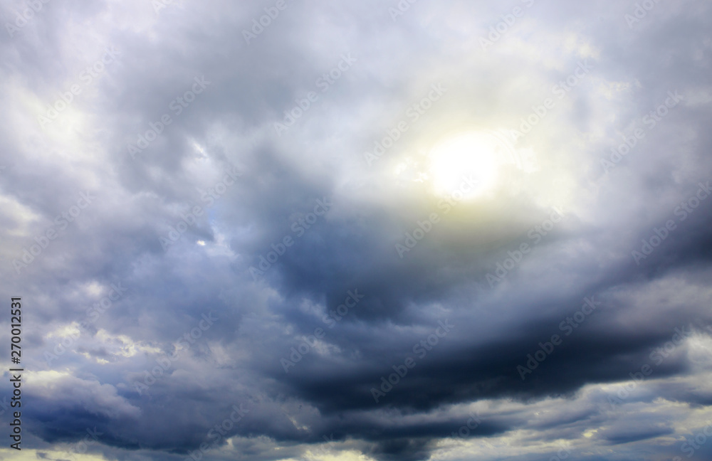 Fototapeta premium Beautiful sunset sky above gray clouds with dramatic light.