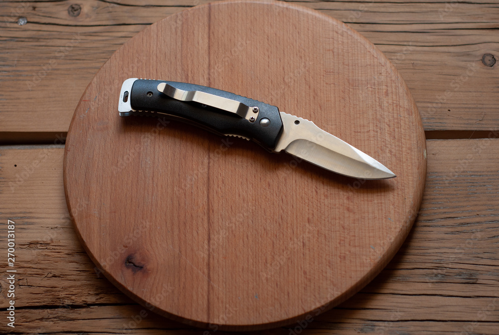 folding knife on a wooden table