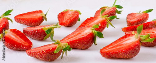 Fototapeta Naklejka Na Ścianę i Meble -  Cut along strawberries on a light background.