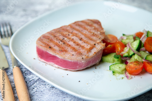 Grilled tuna steak with vegetables. Selective focus, close-up.