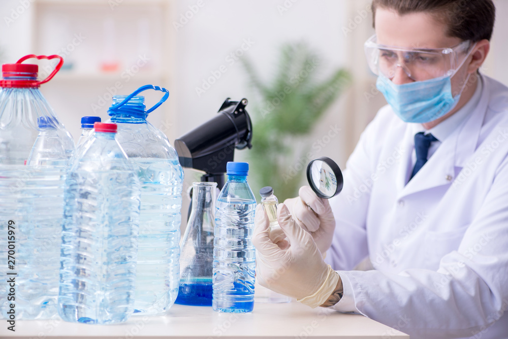Young male chemist experimenting in lab Young male chemist experimenting in lab