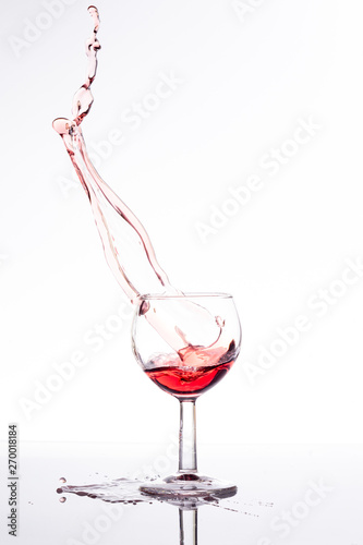 Red wine splash over white background 