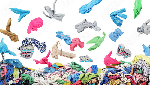 Fotografie Separate clothing falling at the big pile of clothes on a white background