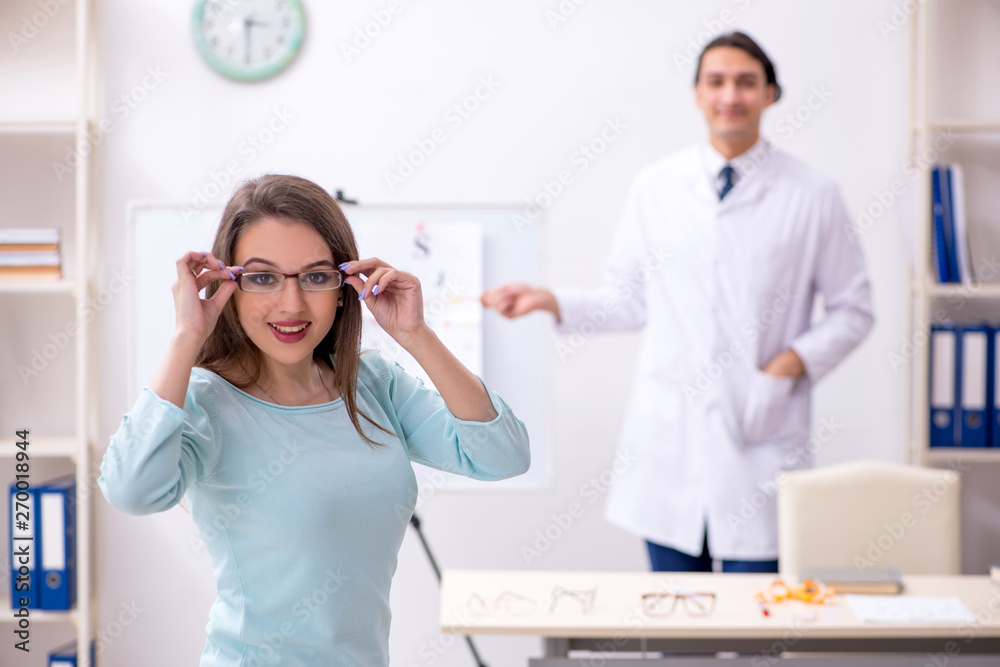 Fototapeta premium Young woman visiting male doctor oculist 