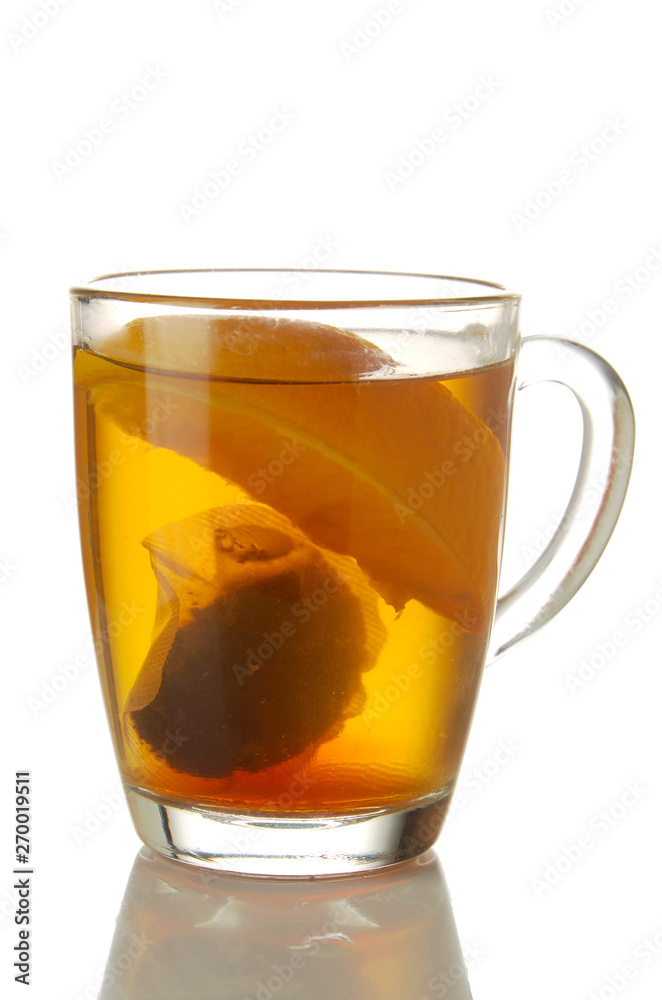 Fresh brewed tea with orange glass mug isolated on white Fresh brewed tea with orange glass mug isolated on white