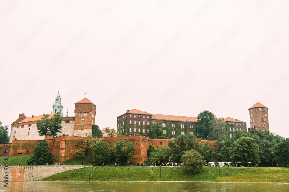 Scenic view at  Wawel castle in Cracow city (Krakow), Poland, from Vistula river (Wisla) quay in summer day.