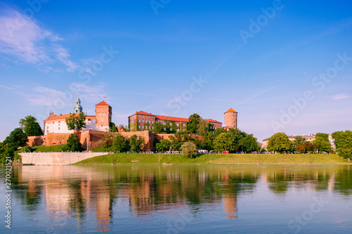  view at Wawel castle in Cracow city (Krakow), Poland, from Vistula river (Wisla) quay in summer sunny with reflections in water