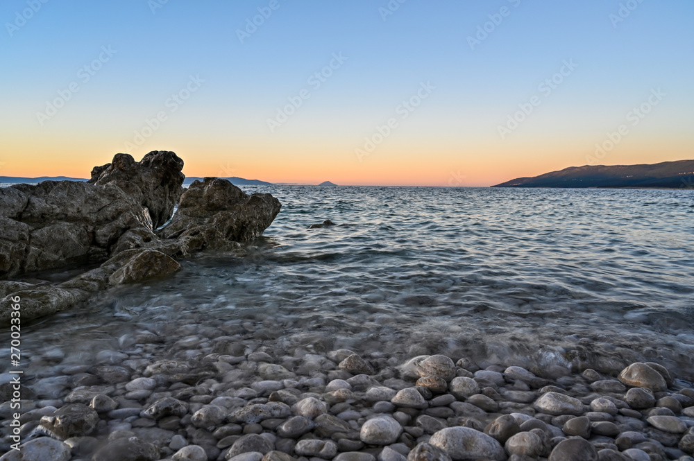 sunrise over a stone beach in Rabac Croatia