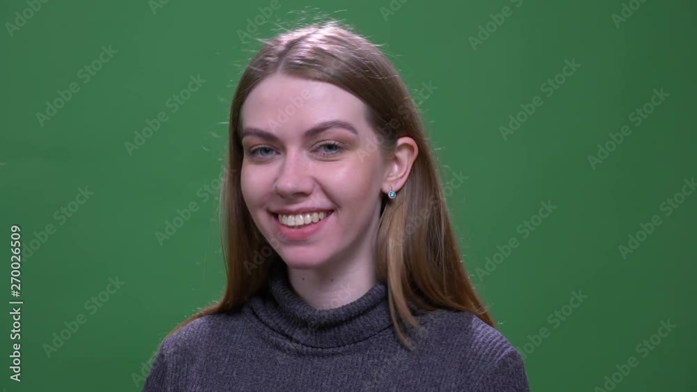 Young blonde model smiling cheerfully into camera isolated on green chromakey background. Young blonde model smiling cheerfully into camera isolated on green chromakey background.