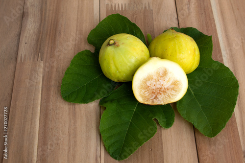 figs with leaves on wooden background