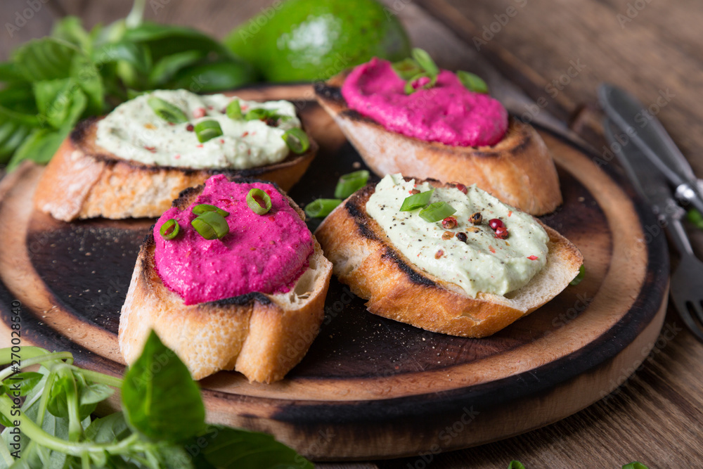 Various bruschettas with avocado and beetroot