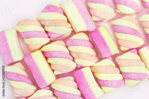 Marshmallow pattern. Gentle yellow and pink striped zephyr. Winter concept. Sweet food background. Top view. © yrabota