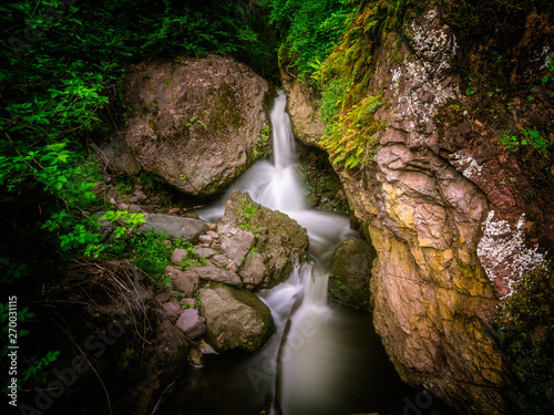 hidden waterfall surrounded by rocks