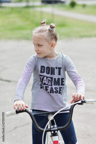 Portrait of a beautiful young girl with a bicycle