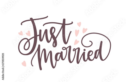 Just Married phrase or inscription written with elegant cursive calligraphic font or script and decorated by cute tiny hearts. Romantic lettering for wedding celebration. Modern vector illustration.