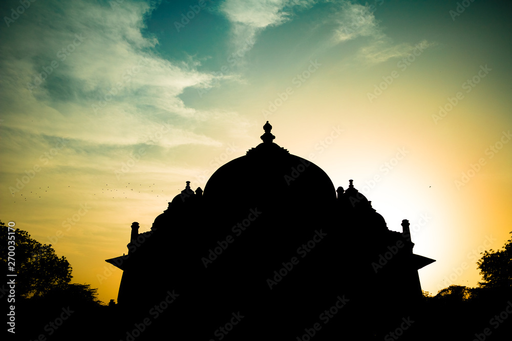 Silhouette of Tomb of Isa Khan in Humayun's Tomb complex in Delhi, India with amazing sky.