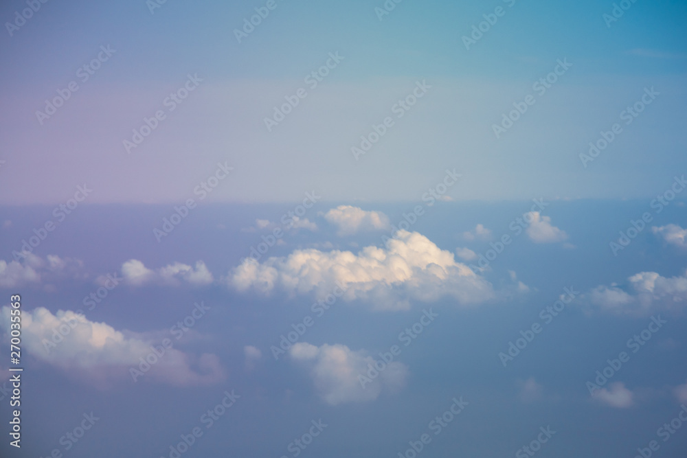 Aerial view from plane window with blue sky and white clouds Aerial view from plane window with blue sky and white clouds