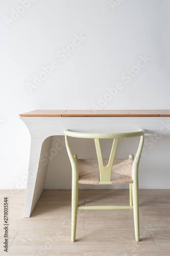 Minimalist architect designer concept with green classic chair and modern table on wooden floor with white wall background.