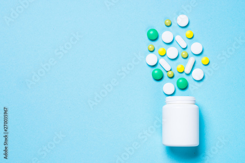 Pills, tablets and vitamin on blue