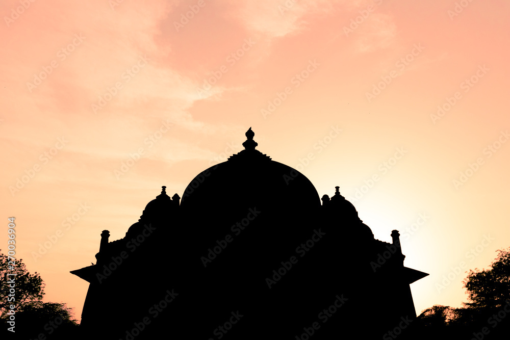 Silhouette of Tomb of Isa Khan in Humayun's Tomb complex in Delhi, India with amazing sky.