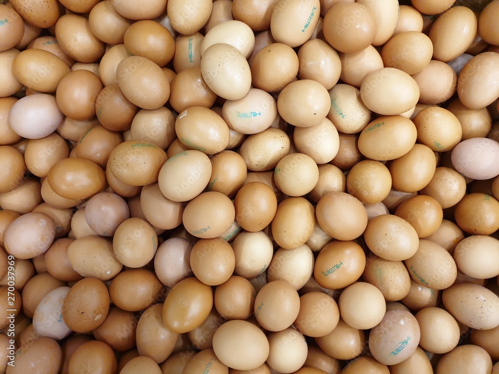 Many eggs lie together on each other, brown eggs, a lot of chicken eggs Many eggs lie together on each other, brown eggs, a lot of chicken eggs