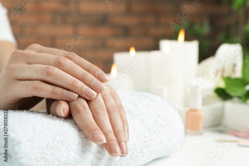 Woman showing smooth hands on towel at table  closeup with space for text. Spa treatment