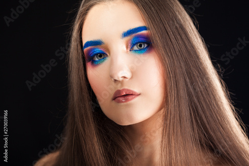 Portrait of a gorgeous beautiful girl with long hair and blue smoky eyes.