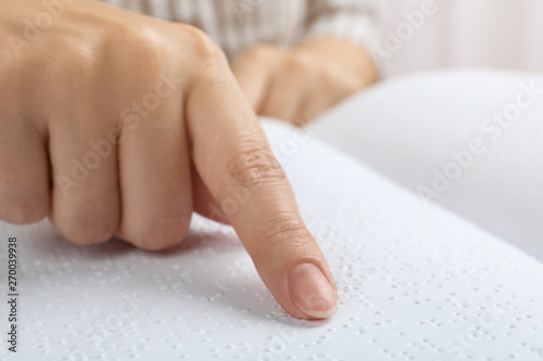 Blind person reading book written in Braille, closeup