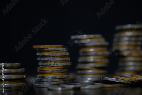 coins stacked on each other in different positions, rows for finance and business concept.