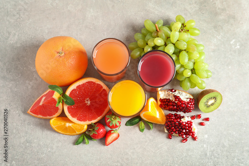 Glasses of different juices and fresh fruits on table, top view © New Africa