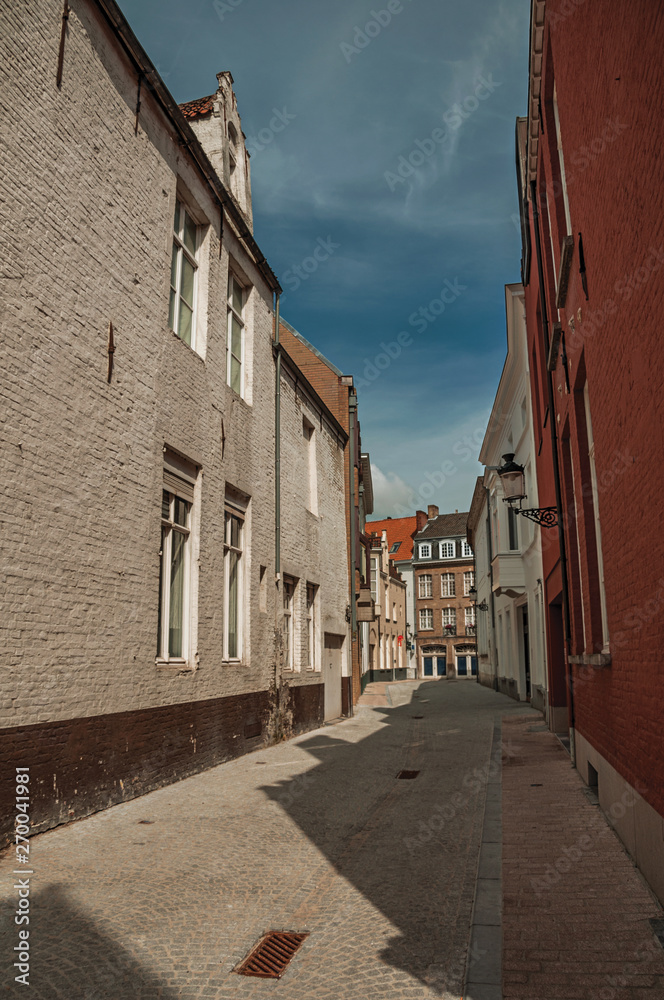Quiet empty street with brick buildings at Bruges