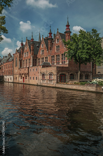 Brick buildings on the canal in a sunny day at Bruges