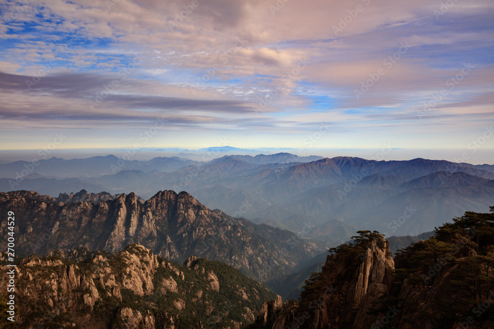 Fototapeta premium Huangshan China National Park - Anhui Province, Chinese Mountain Peak. Viewing Platform, Yellow Granite Mountains with Canyon, Exotic Pine Trees and Forest, Jagged Cliffs, UNESCO World Heritage Site