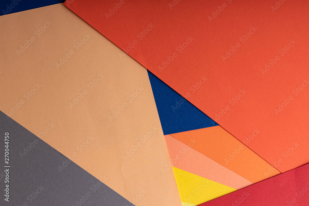 Sheets of colored paper are on the table. Paper of blue, yellow, green, blue, red, coral and peach colors. Abstract creative background Sheets of colored paper are on the table. Paper of blue, yellow, green, blue, red, coral and peach colors. Abstract creative background