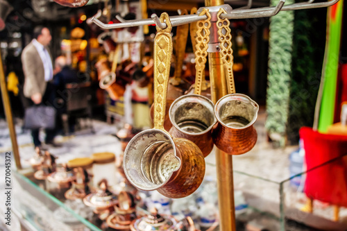 Traditional decorated Turkish copper coffee pots or cezve hanging in the Turkish market in Istanbul