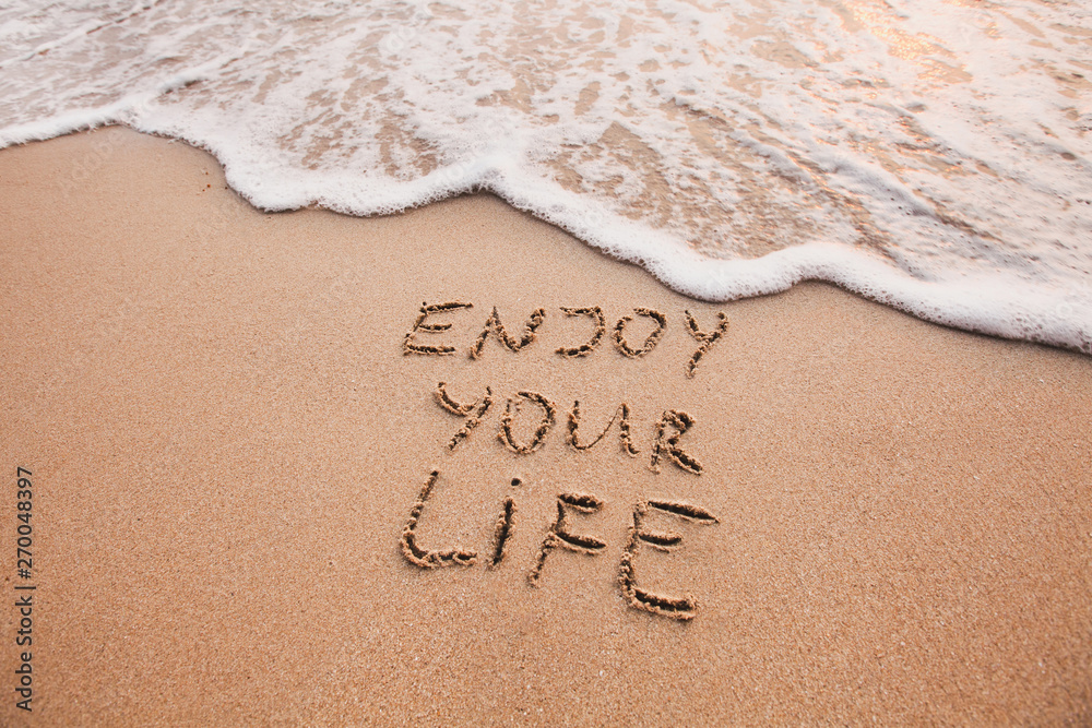 Enjoy your life, happiness concept, positive thinking, inspirational quote written on sand beach. - obrazy, fototapety, plakaty 